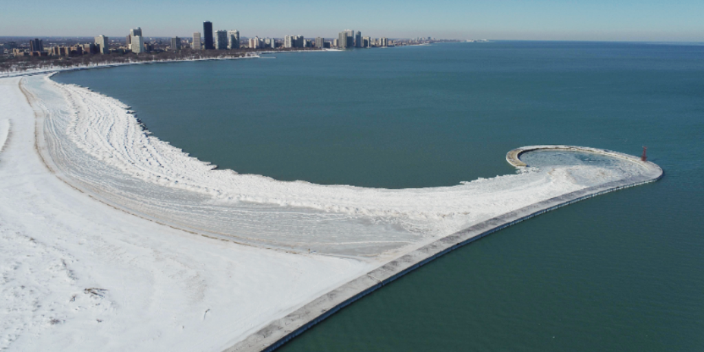 Frozen path with snow on Lake Michigan's shore.